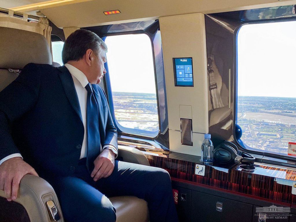 Picture of the president of Uzbekistan sitting on a plane and looking out the window