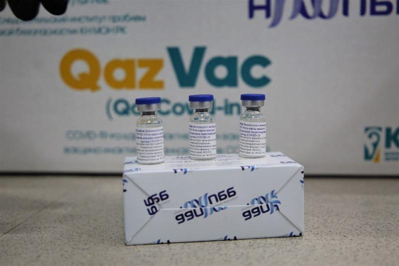 Three bottles of the QazVac vaccine on a box