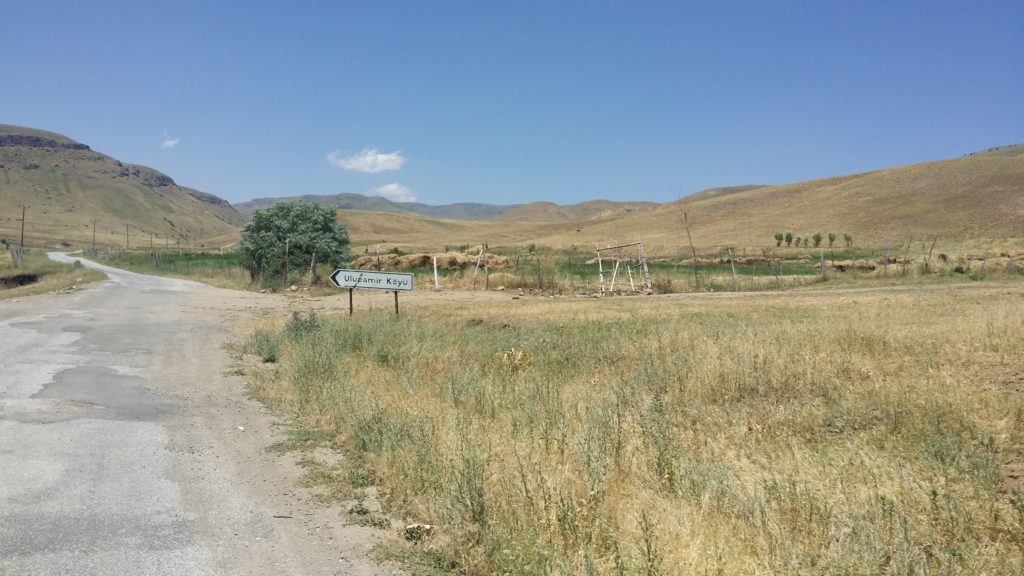 A sign post points towards the village of Ulupamir.