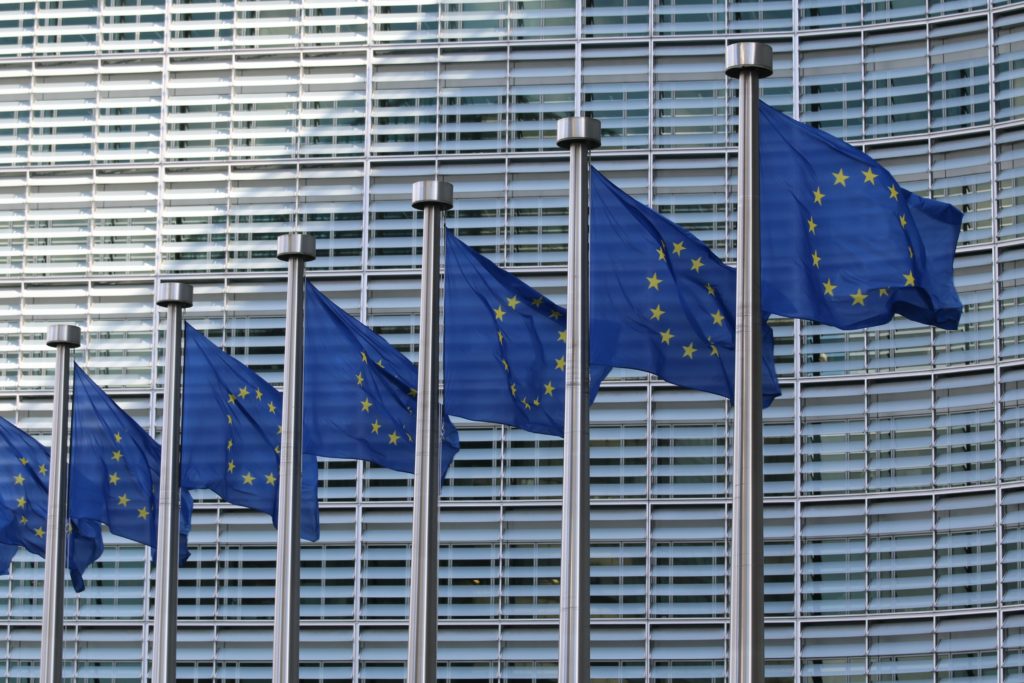 EU flags at the European Commission Berlaymont building in Brussels, Belgium. Photo by Guillaume Périgois/Unsplash.