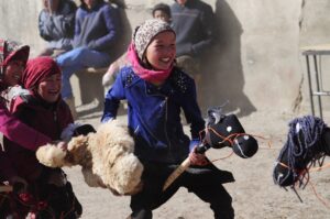 Little girls playing 'kids-buzkashi' in the remote village of Karakul, situated along the Pamir Highway, Tadjikistan.