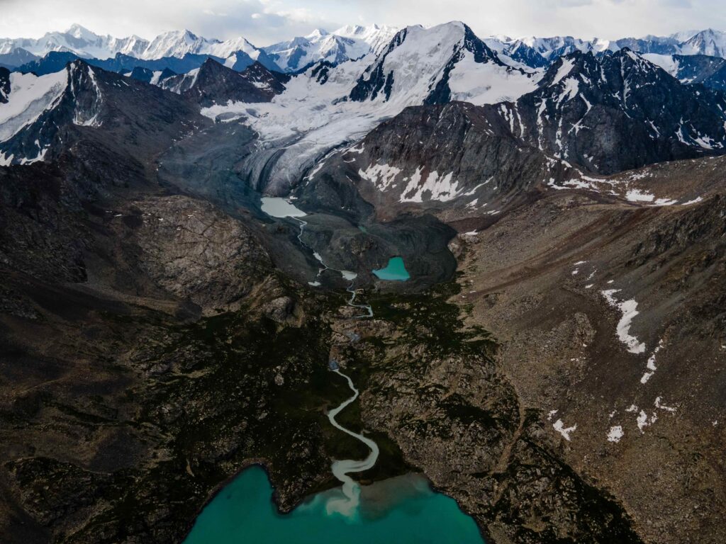 high snow-capped mountains, glacier and turquoise lake