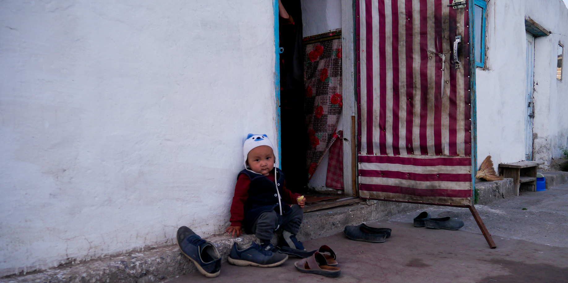 A child outside is home in Sary-Mogol