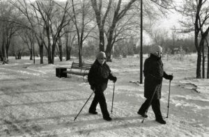 women coats snow park sticks trees