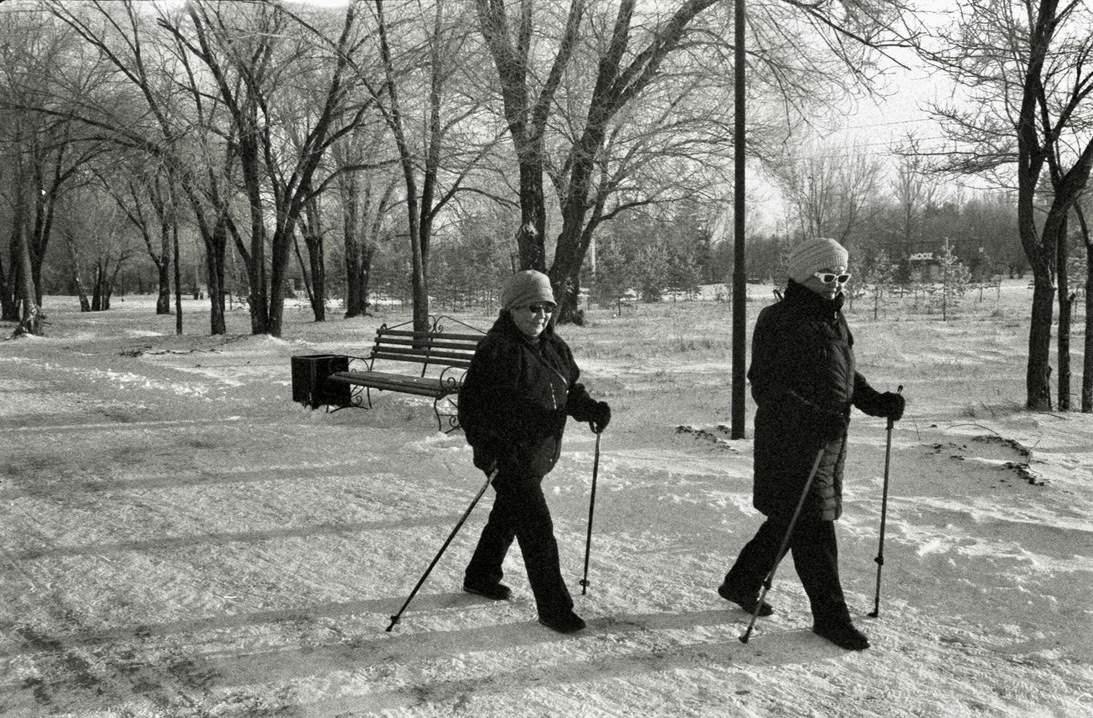 women coats snow park sticks trees