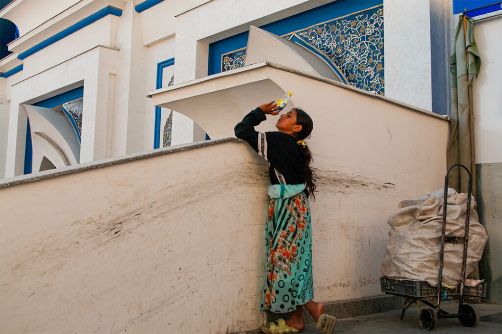 A young girl quenching her thirst in Tashkent