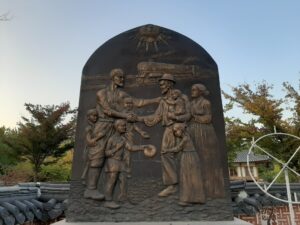 A memorial in Seoul Garden, Tashkent, commemorates the 1937 deportation of Koreans to Uzbekistan. The relief shows a deportation train and a Korean family being welcomed by an Uzbek elder. Photo: Mathieu Lemoine.