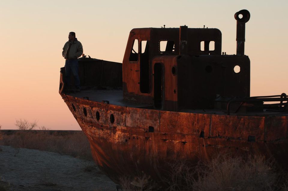 Oktyabr Dospanov aboard one of the abandoned ships in Muynak, once a major fishing port on the Aral Sea. Photo: Ernest Kurtveliev.