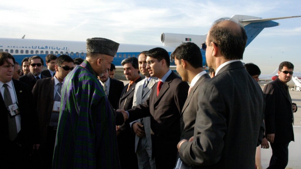 Afghan President Hamid Karzai greets a delegation upon his arrival in Madrid to attend the International Summit on Democracy, Terrorism and Security, held from 8 to 10 March 2005. His visit preceded the establishment of resident embassies in Madrid and Kabul. Photo: Courtesy of Hamed Wahdat Ahmadzada.