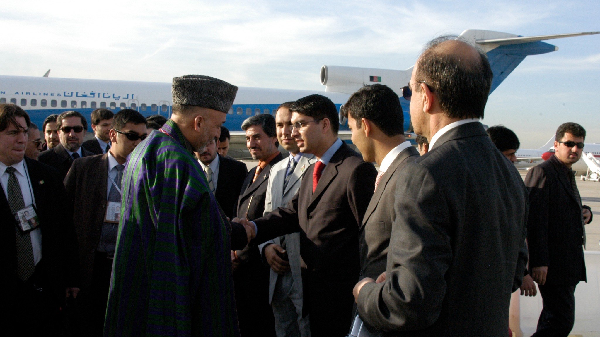 Afghan President Hamid Karzai greets a delegation upon his arrival in Madrid to attend the International Summit on Democracy, Terrorism and Security, held from 8 to 10 March 2005. His visit preceded the establishment of resident embassies in Madrid and Kabul. Photo: Courtesy of Hamed Wahdat Ahmadzada.