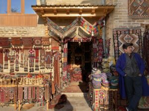 marchand de tapis à Boukhara devant sa boutique