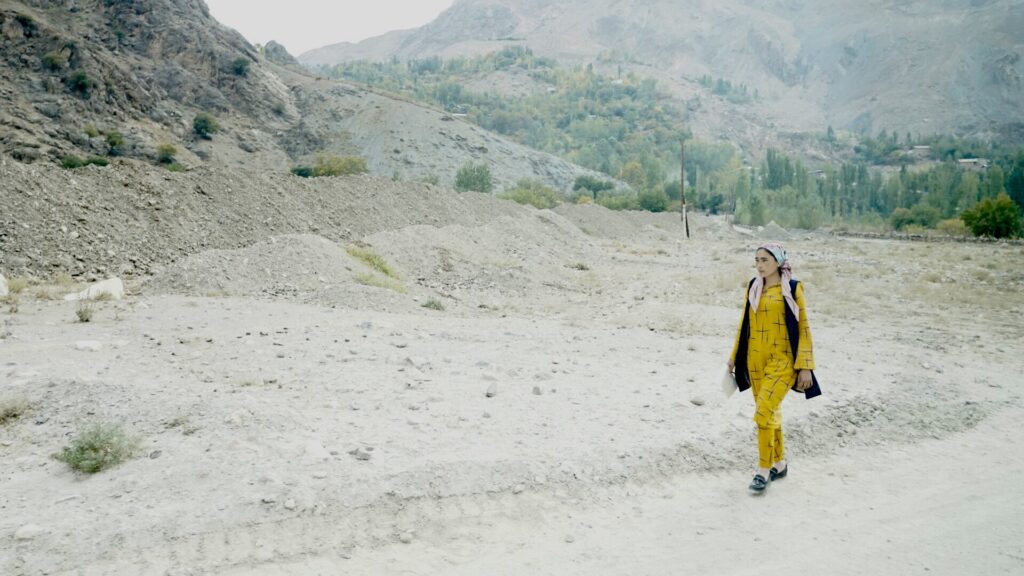 Jeune femme marchant sur les hauts plateaux du Tadjikistan.